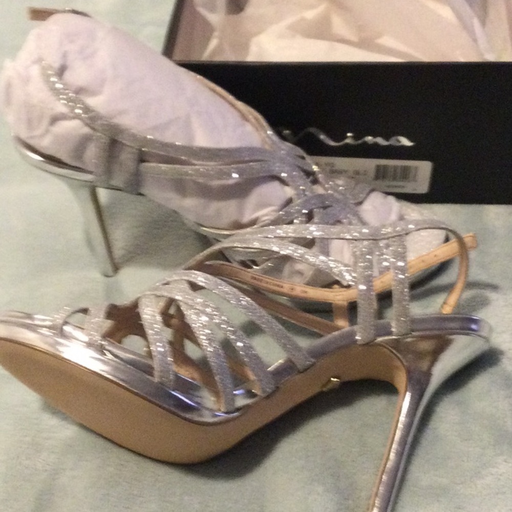 Brand new in box - never worn.  Exquisite silver glitter dress sandals.